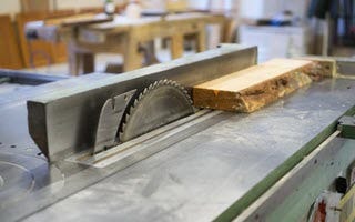 wood sitting on top of a table saw