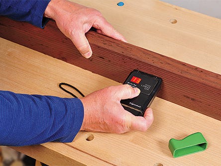 Testing the moisture content of lumber with a moisture meter