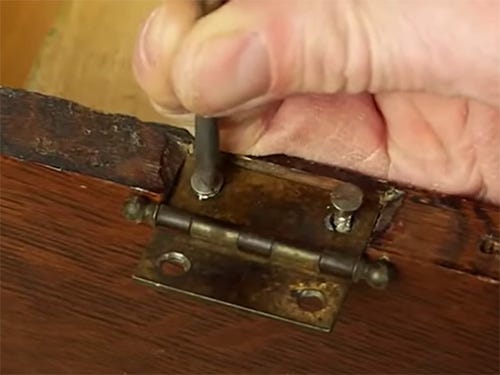 Tightening screws around hinge on antique project