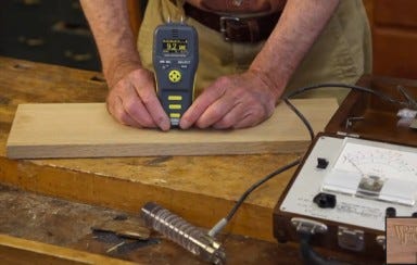 Checking moisture content of wood with a moisture meter