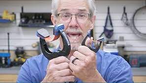 man holding a pair of bandy clamps