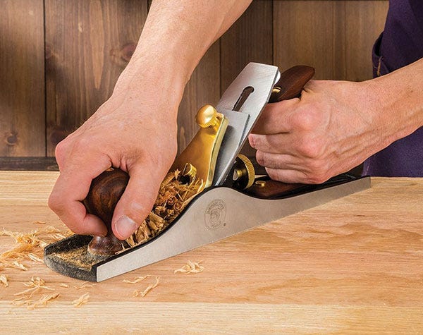 smoothing a board with a hand plane