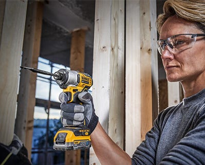 woman using dewalt drill