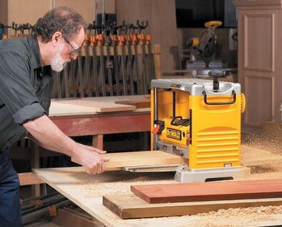 man using dewalt planer