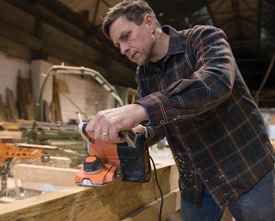 man sanding with a triton sander