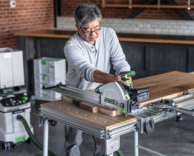 Man operating a track saw