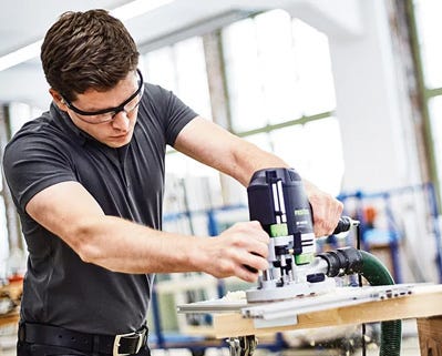 Man operating a sanding machine