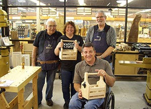 make and take group photo holding the bottle caddies they made