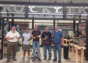 make and take class group photo holding the pizza cutters they made