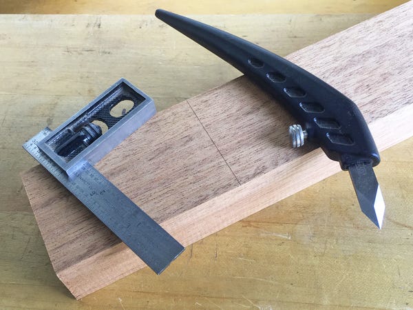 A mark made on a piece of wood with a straight edge and a knife